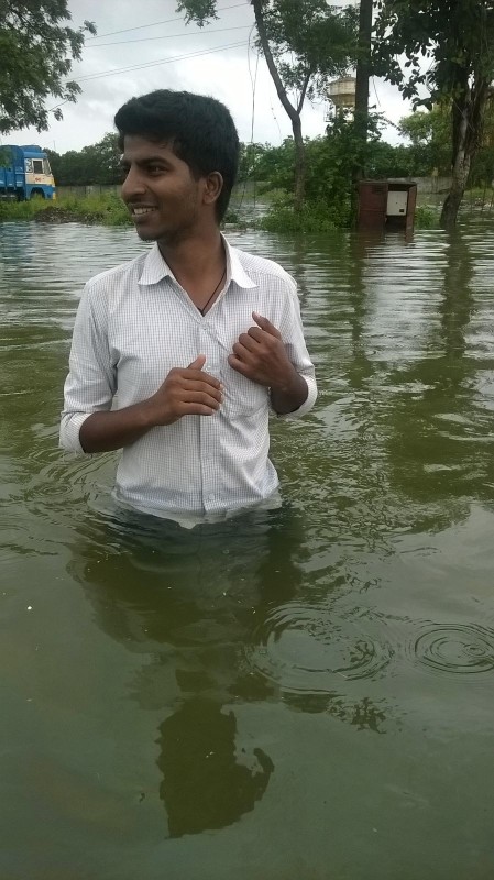 Our-associate-wading-through-water-near-the-office-449x800